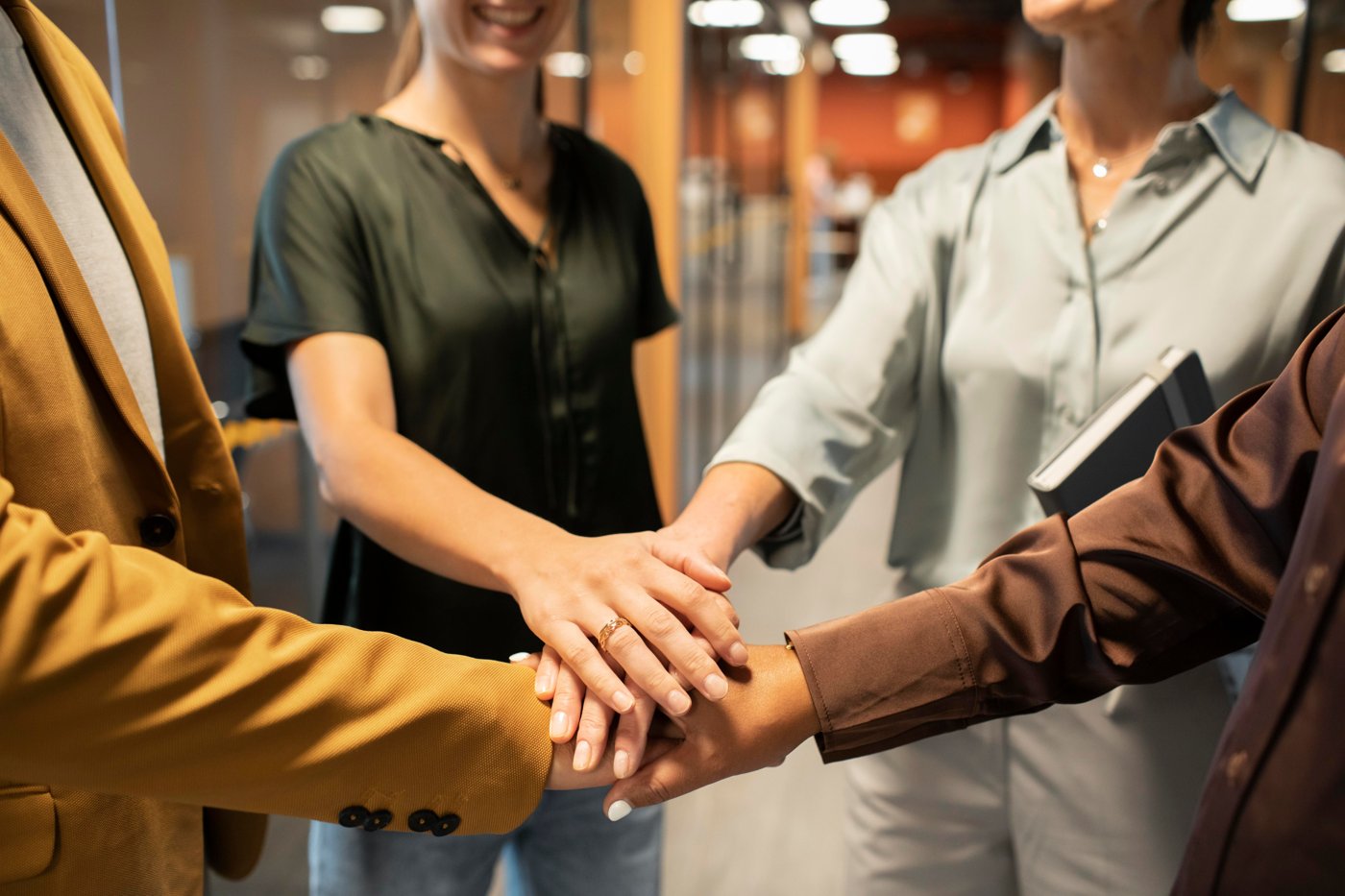 Team members joining hands in partnership